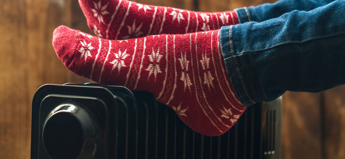Women's,Feet,In,Christmas,,Warm,,Winter,Socks,On,The,Heater.